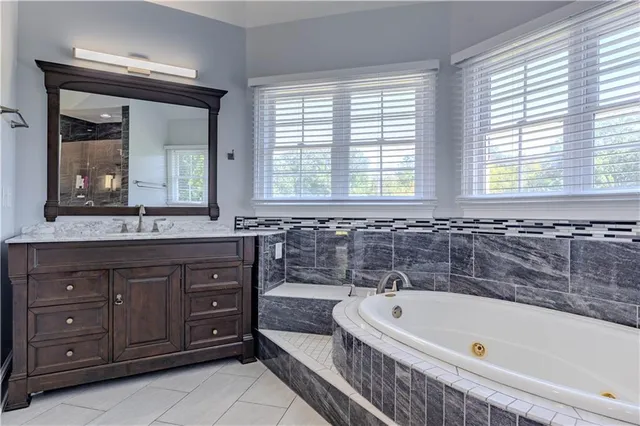 an empty room with a window and a chandelier fan