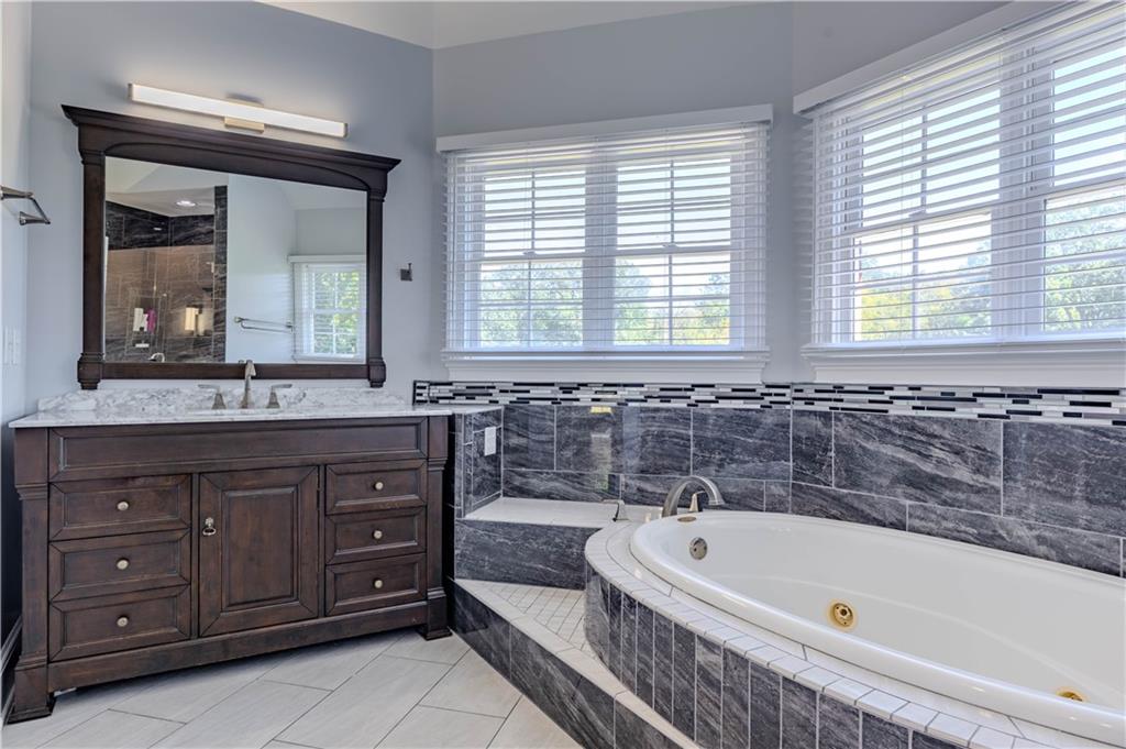 48 Fox Croft Road Rome, GA 30165 - Photo 34 of 69 a bathroom with a tub a double vanity sink and a large mirror