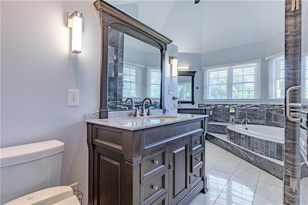 48 Fox Croft Road Rome, GA 30165 - Photo 37 of 69 a bathroom with a granite countertop sink a toilet a mirror and a bathtub