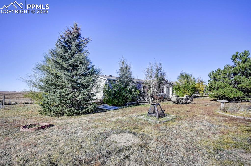 35355 Funk Road Calhan, CO 80808 - Photo 2 of 31 View of green lawn featuring a patio area