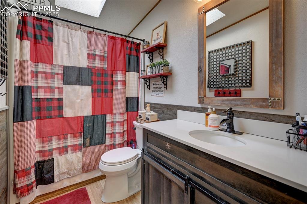 35355 Funk Road Calhan, CO 80808 - Photo 27 of 31 a bathroom with a sink a toilet and shower curtain