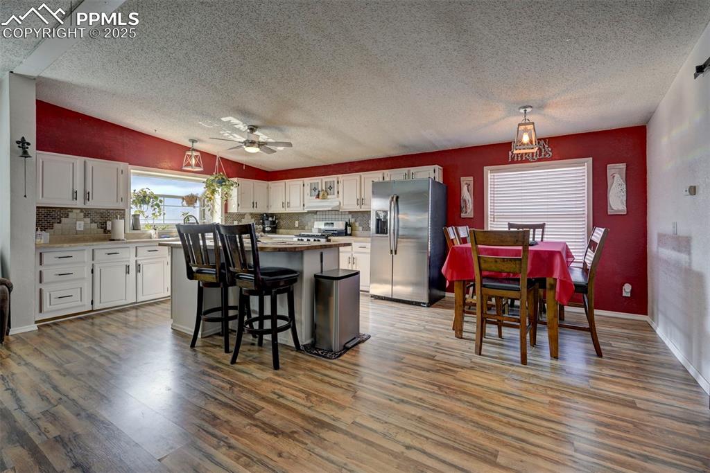 35355 Funk Road Calhan, CO 80808 - Photo 10 of 31 a view of a dining room with furniture and wooden floor