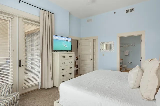 a bedroom with a bed and a television