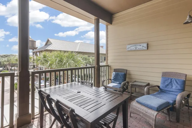 a view of a balcony dining area with furniture