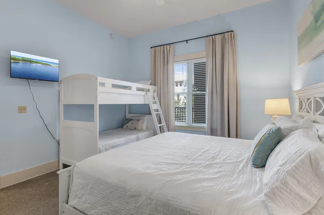 a bedroom with a bed and a lamp