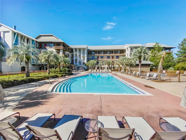 a view of a swimming pool with outdoor seating