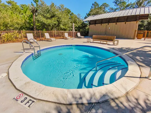 a swimming pool with outdoor seating and yard