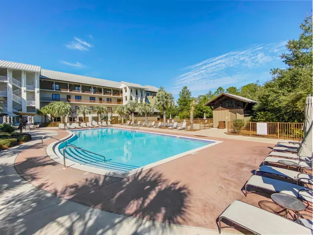a view of a swimming pool with outdoor seating