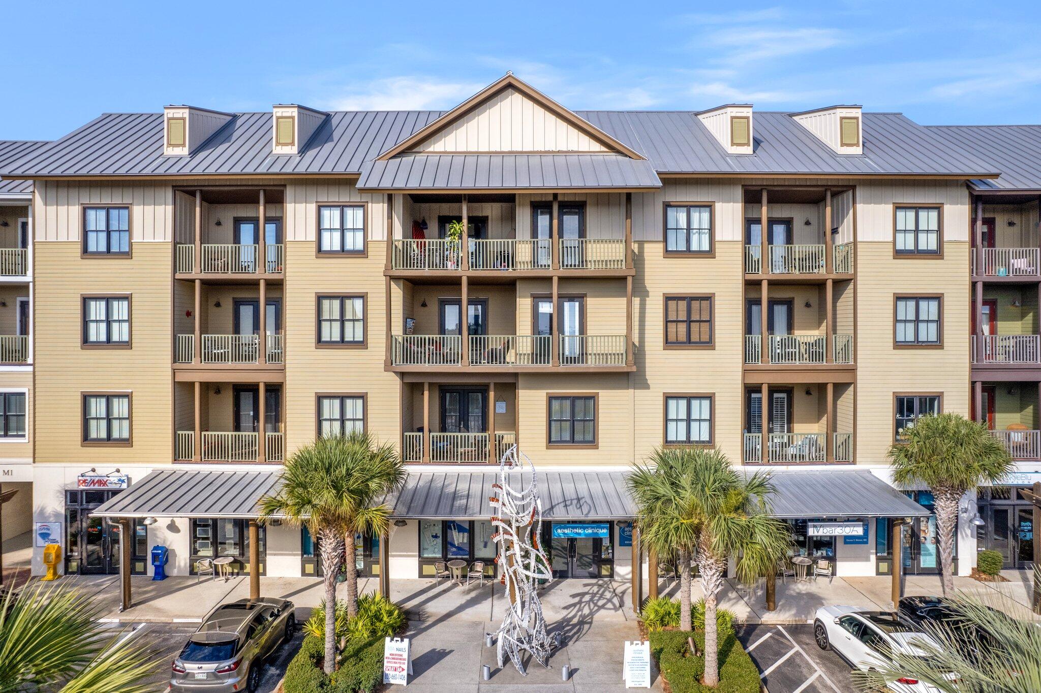 2050 West County Highway 30A, Unit M1219 Santa Rosa Beach, FL 32459 - Photo 40 of 47 a front view of a residential apartment building with a yard
