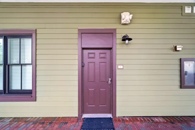 a view of a patio with table and chairs with wooden floor and fence