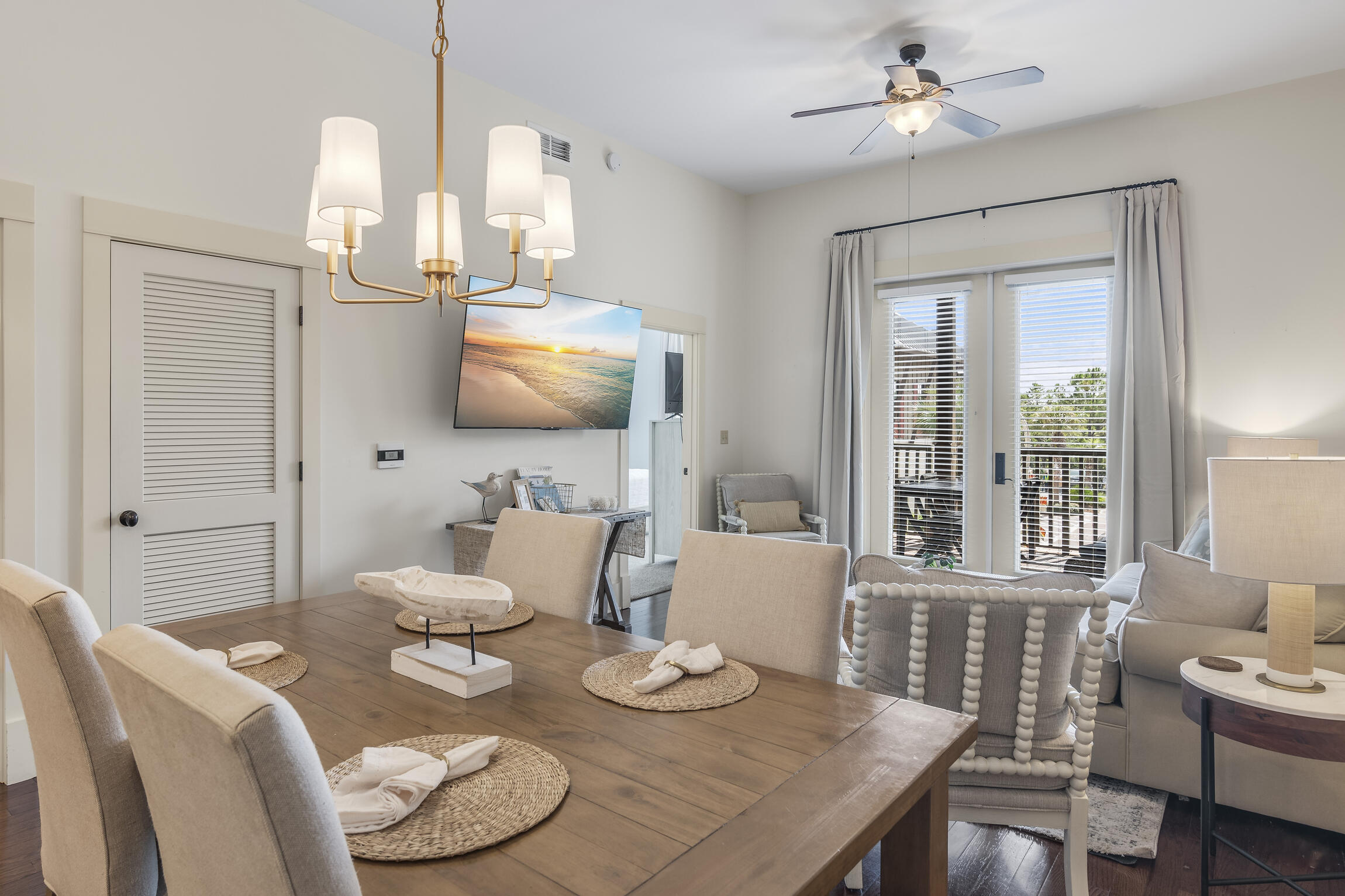 2050 West County Highway 30A, Unit M1219 Santa Rosa Beach, FL 32459 - Photo 5 of 47 a view of a dining room with furniture a chandelier and wooden floor