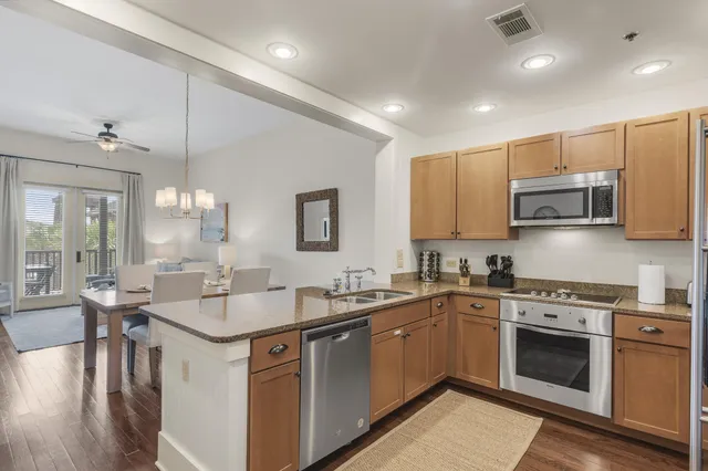 a kitchen with a sink stove a microwave and cabinets