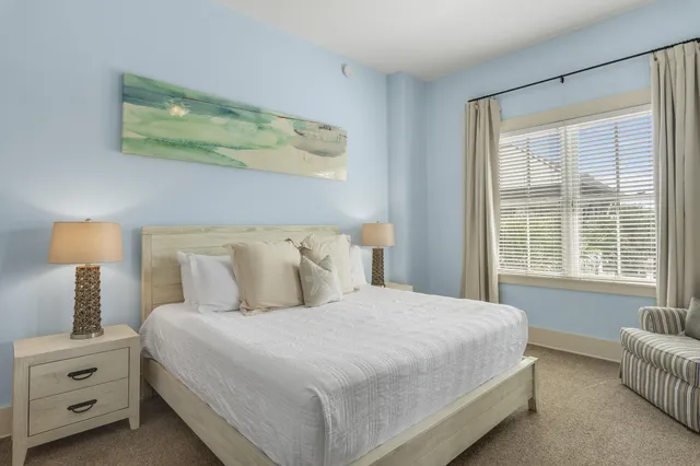 a bedroom with bed and window with lamp