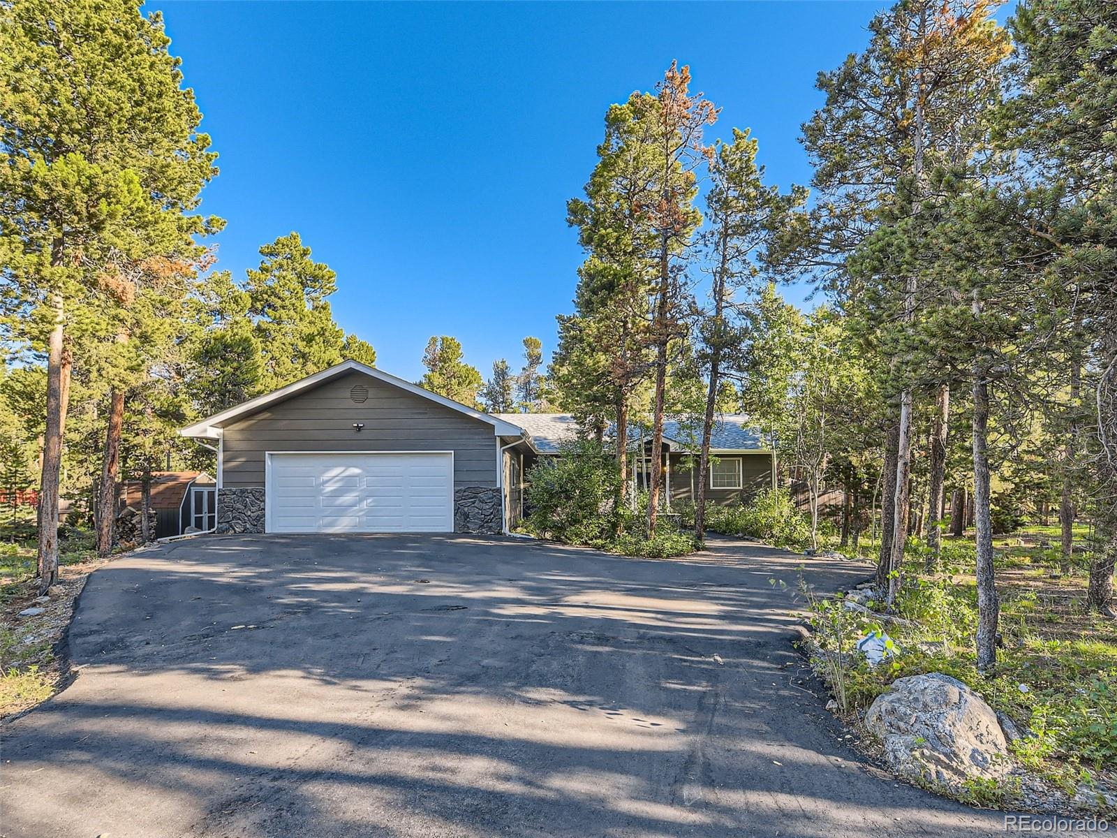 161 Gap Road Black Hawk, CO 80422 - Photo 1 of 28 a front view of a house with a yard and garage
