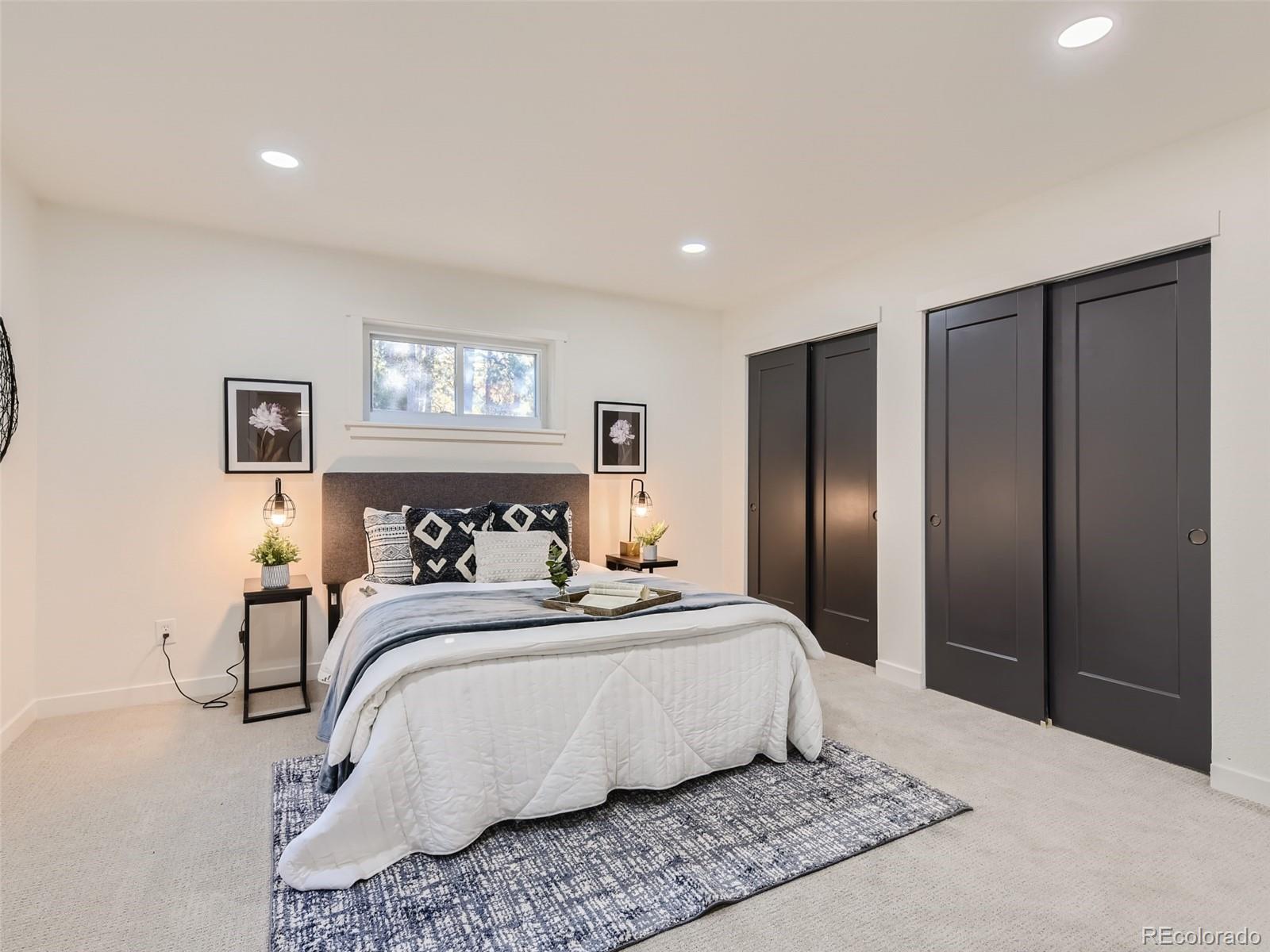 161 Gap Road Black Hawk, CO 80422 - Photo 11 of 28 a bedroom with a large bed and a refrigerator