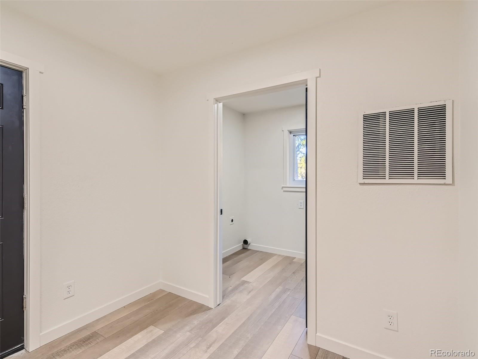 161 Gap Road Black Hawk, CO 80422 - Photo 18 of 28 an empty room with wooden floor and a window