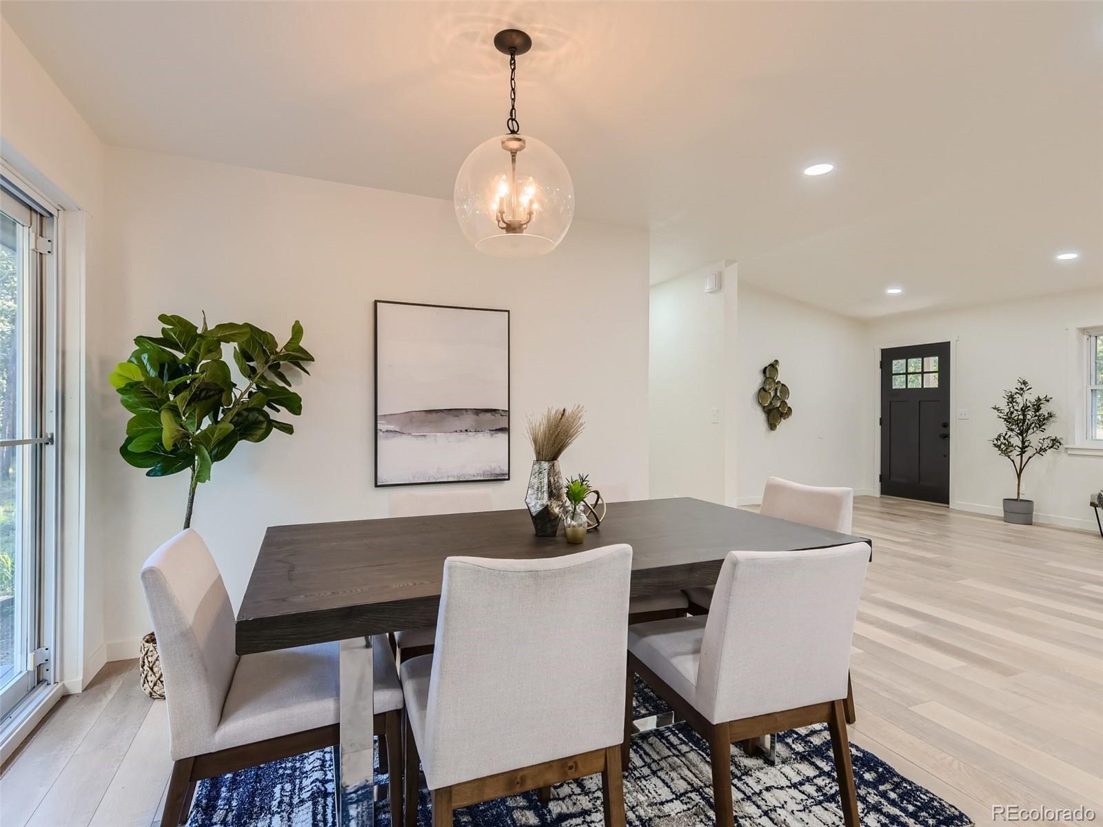 161 Gap Road Black Hawk, CO 80422 - Photo 28 of 28 a dining room with furniture potted plants and wooden floor
