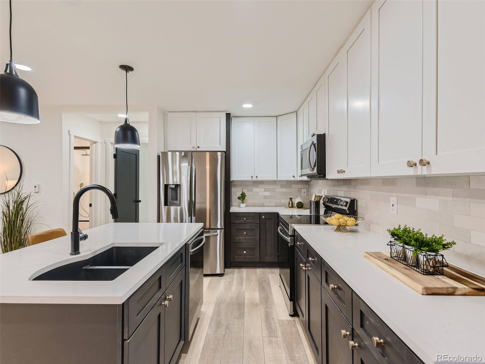 161 Gap Road Black Hawk, CO 80422 - Photo 8 of 28 a kitchen with kitchen island stainless steel appliances a sink a stove and refrigerator
