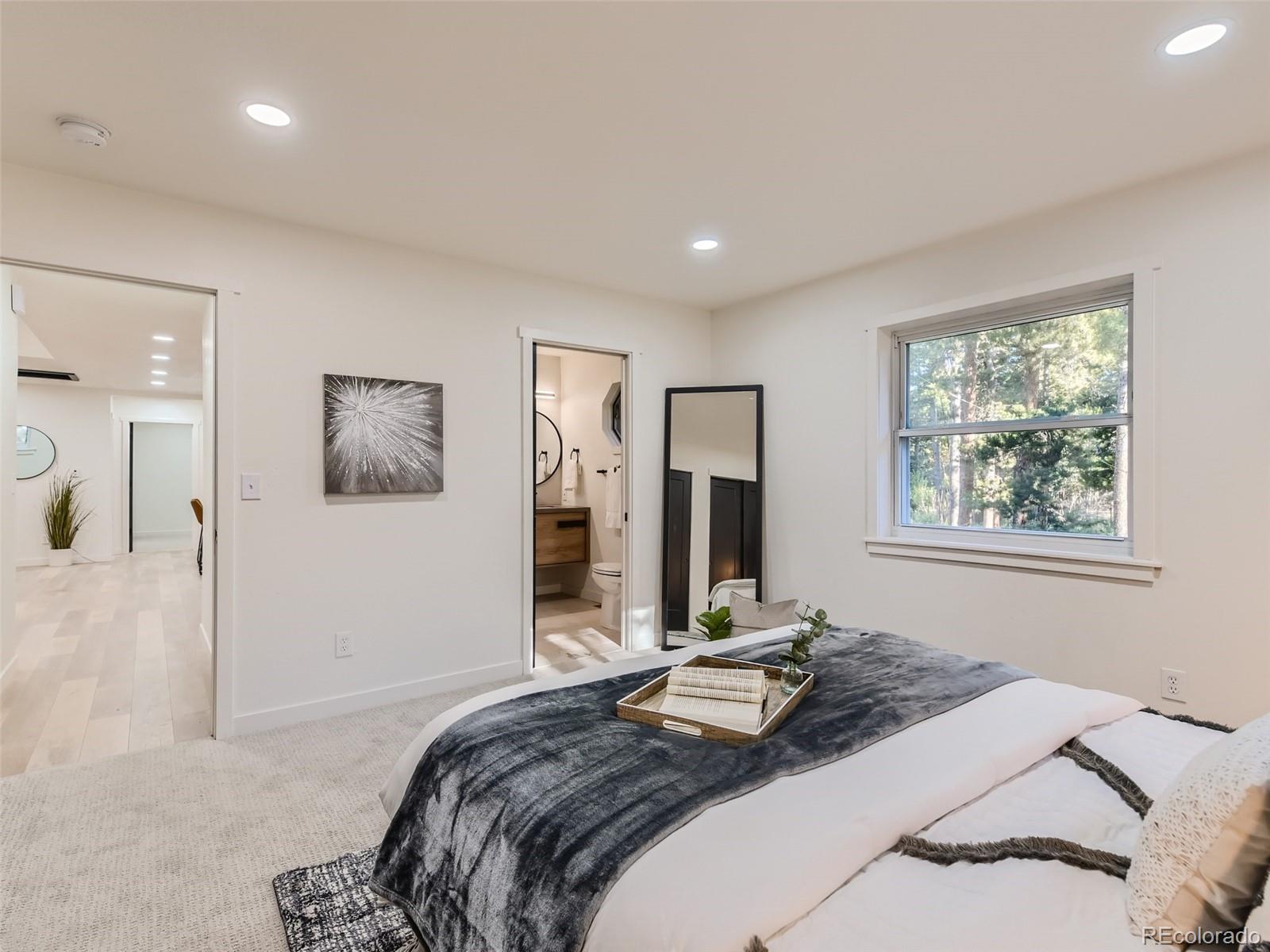 161 Gap Road Black Hawk, CO 80422 - Photo 10 of 28 a bedroom with a bed and a large mirror