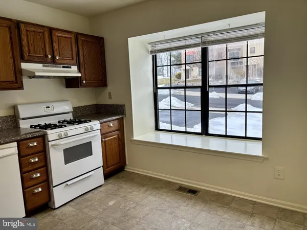 a kitchen with stainless steel appliances granite countertop a stove and a microwave