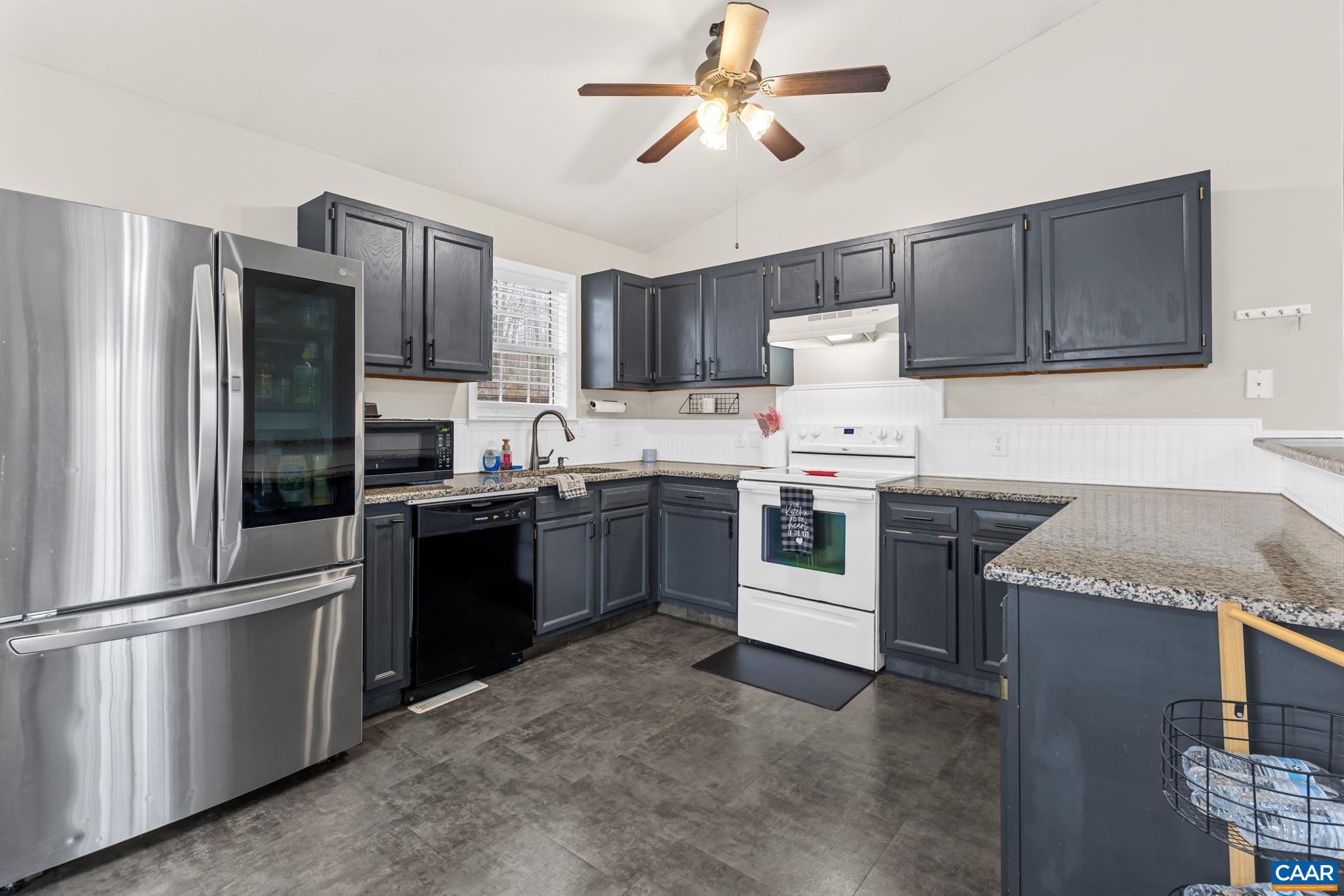 1029 West Daffodil Road Ruckersville, VA 22968 - Photo 17 of 39 a kitchen with a stove refrigerator and microwave