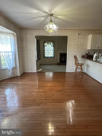 a view of a livingroom with furniture window and wooden floor