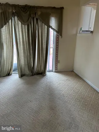 a view of a room with staircase and door