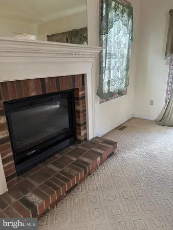 a living room with a fireplace and a window