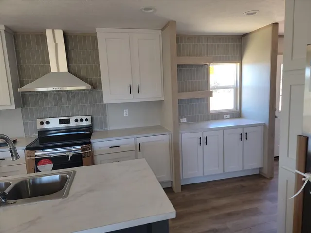 a kitchen with a stove a refrigerator and a sink