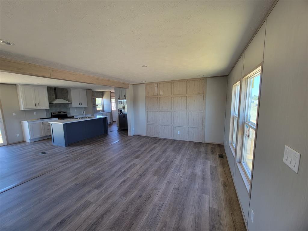 387 Duvall Street Bonham, TX 75418 - Photo 2 of 24 a view of a kitchen with a sink and a stove top oven