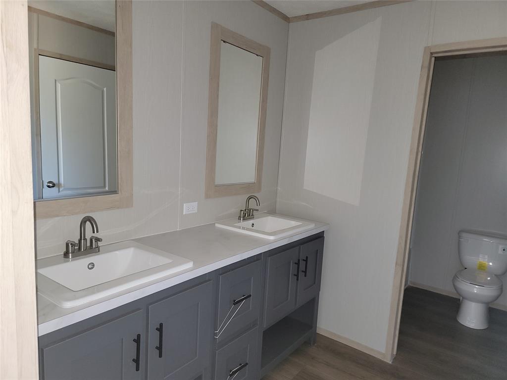 387 Duvall Street Bonham, TX 75418 - Photo 21 of 24 a bathroom with a sink and a toilet