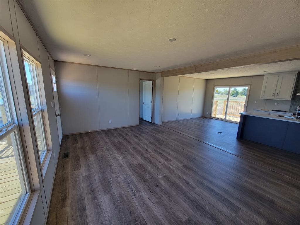 387 Duvall Street Bonham, TX 75418 - Photo 3 of 24 an empty room with wooden floor and windows