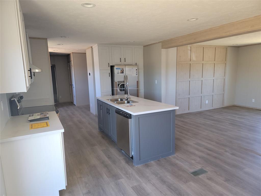 387 Duvall Street Bonham, TX 75418 - Photo 7 of 24 a kitchen with stainless steel appliances a white stove top oven and a refrigerator