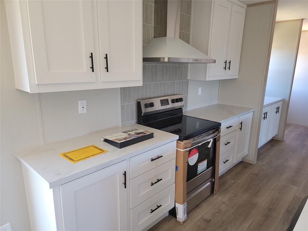 387 Duvall Street Bonham, TX 75418 - Photo 9 of 24 a kitchen with appliances cabinets and a sink