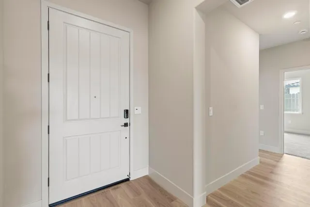 a view of a hallway with wooden floor
