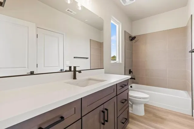a bathroom with a sink a toilet and a bathtub