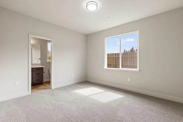 an empty room with windows and closet