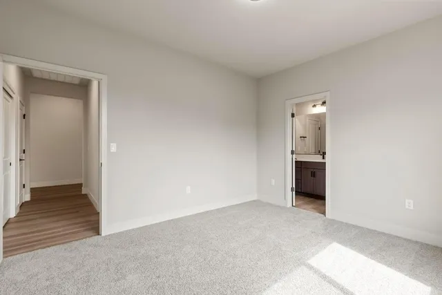 a view of a room with an empty space and wooden floor