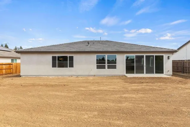 a view of an house with backyard space and balcony