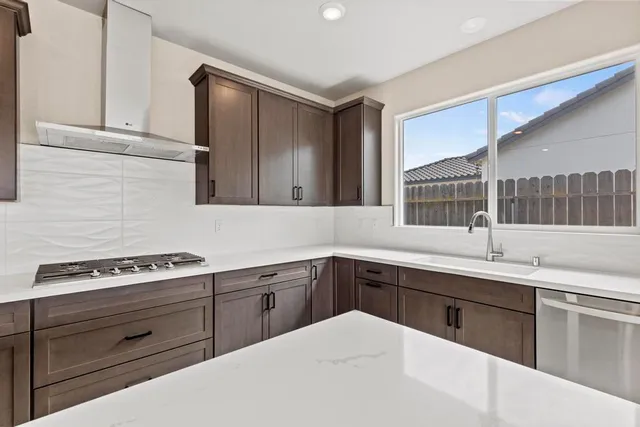a kitchen with a sink stove and cabinets