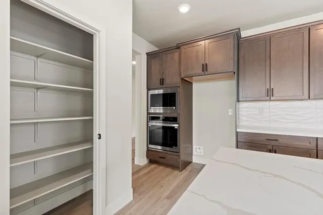 a kitchen with granite countertop cabinets and refrigerator