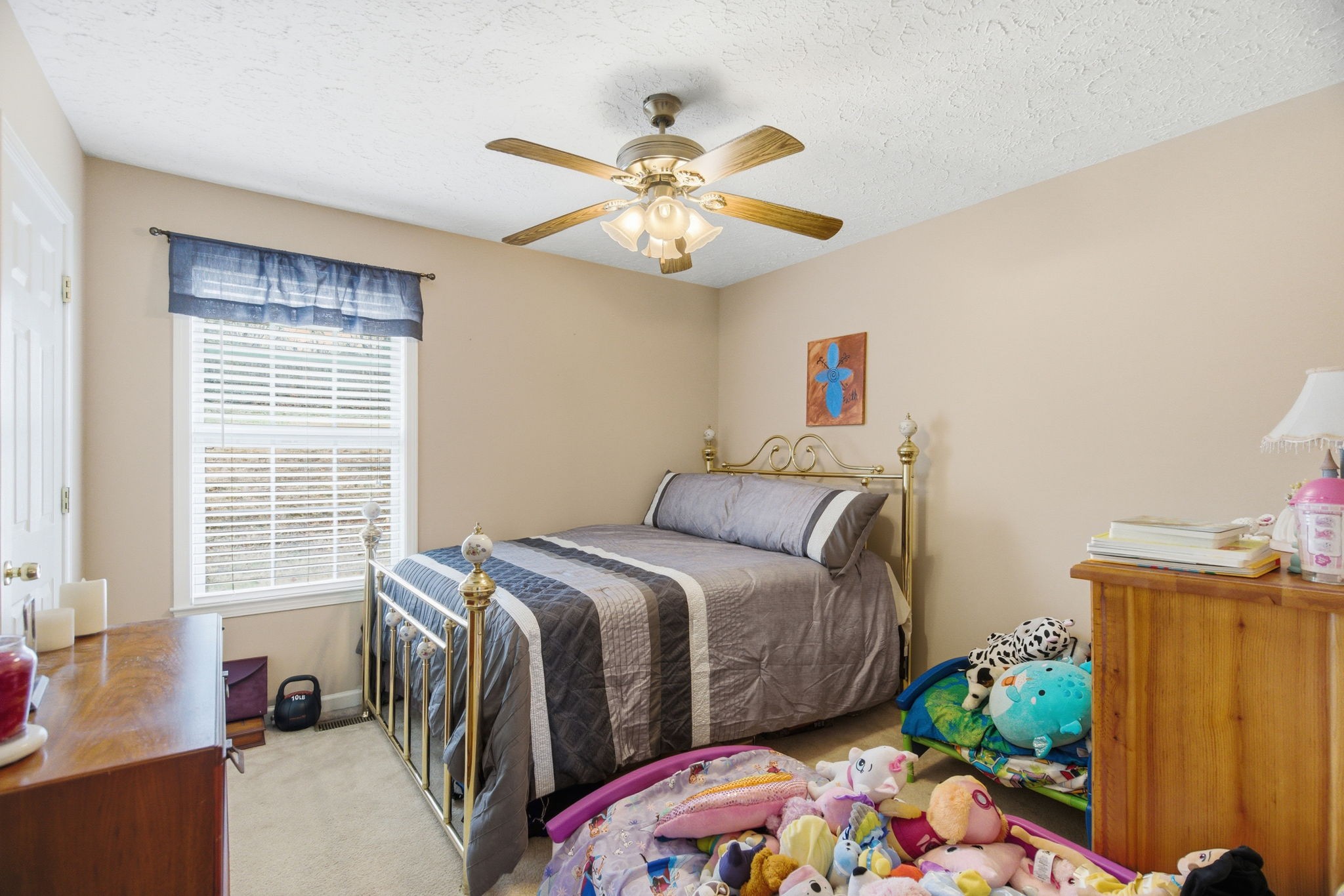 742 Bowling Branch Road Cottontown, TN 37048 - Photo 33 of 42 a bedroom with a bed and a chandelier