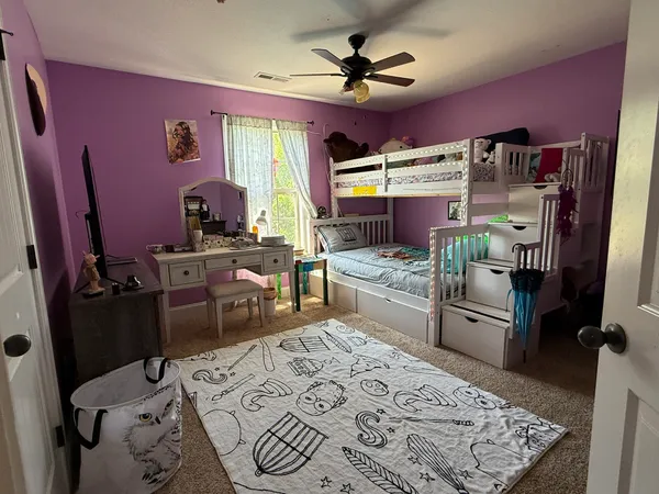 a bed room with a bed and a television