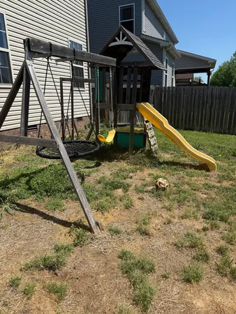 a view of a house with backyard and sitting area