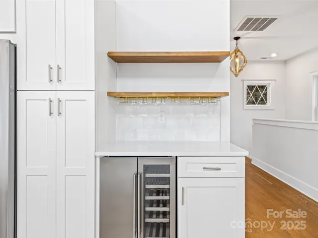 a view of an empty room with a fireplace and a window