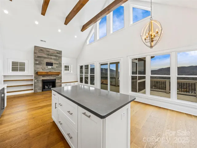 a view of a kitchen with refrigerator and cabinets