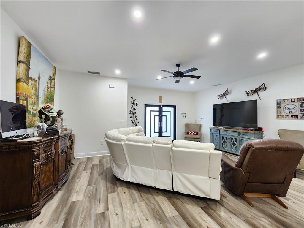 4045 34th Avenue Southeast Naples, FL 34117 - Photo 11 of 30 Living area featuring light wood-style flooring, a ceiling fan, and recessed lighting