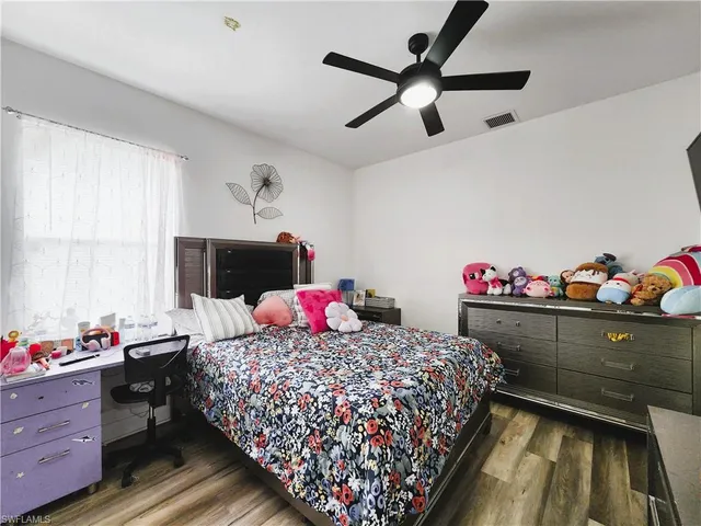 a bedroom with a bed closet and a window