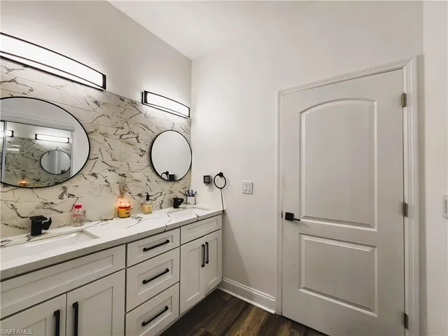 a bathroom with a mirror sink and vanity
