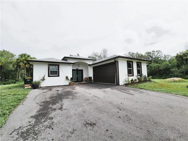 a front view of house with yard and green space